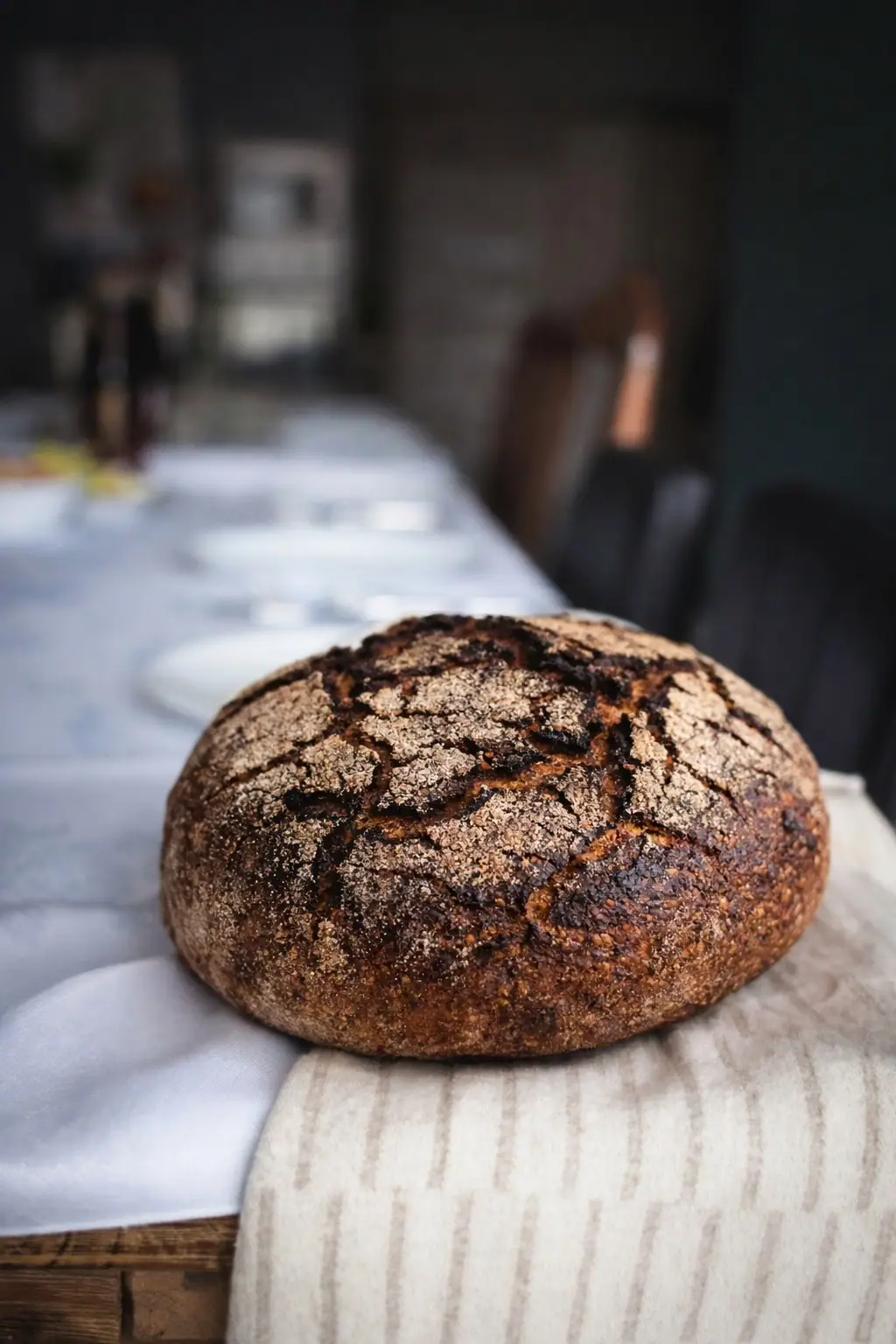 A rye loaf on a laid table